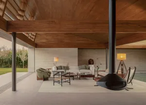 Cozy living space with a fireplace, modern furniture, and natural light from windows