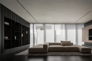 Bright and inviting living room with a white couch, rug, and natural light, connected to a dining area through a sliding glass door