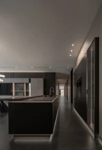 Bright and inviting kitchen and dining area with a black countertop, dining table, and natural light
