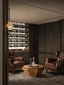 Elegant living room with two brown leather chairs, a dining table, and wine bottles, featuring a sophisticated atmosphere