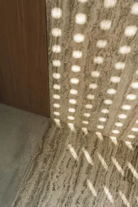 Cozy hallway with a wooden door, marble floor, and dim lighting
