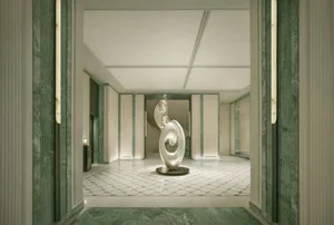 A well-lit, modern room with a white color scheme, a circular sculpture, chandelier, and decorative vase, creating an elegant and sophisticated atmosphere
