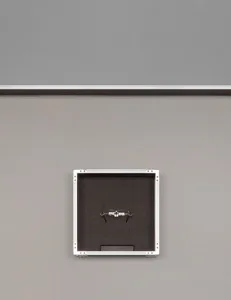A black and white photograph of a concrete wall with a rectangular display case featuring a glass front, mounted on it