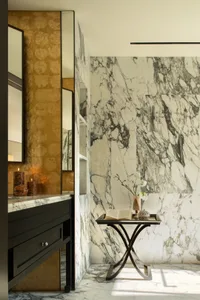 Bathroom with a marble countertop, black vanity, and dim lighting creating a relaxing atmosphere