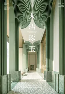 A bright and welcoming lobby with green walls, Asian writing, a bench, chair, and potted plant, filled with natural light