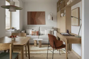 Comfortable and inviting living space with a wooden floor, natural light, and modern furniture