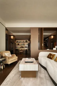 Warm and inviting living and dining space with wooden furniture, decorative items, and natural lighting