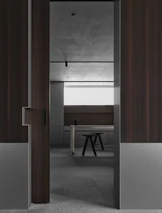 Small office space with a wooden door, a desk, and a chair, set against a simple background