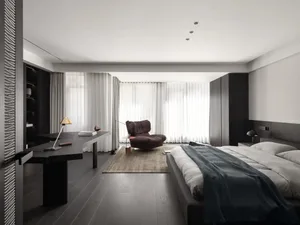 Cozy bedroom with a hardwood floor, a bed, a chair, and a desk, well-lit and inviting