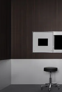 A modern living space with a wooden wall, a black table, and two square mirrors mounted on the wall, reflecting the room's interior in a dimly lit atmosphere