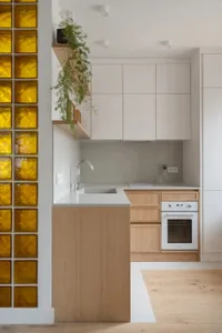A bright and inviting kitchen and dining room with a predominantly white space, wooden elements, and natural lighting