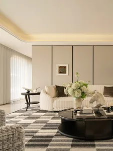 Comfortable living space with a couch, chair, and dining table, decorated with a vase of flowers and well-lit