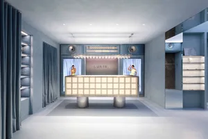 Modern bar lounge with a white counter, chairs, and ambient lighting, featuring a sign above the counter and two people in the scene