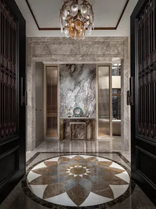 A dimly lit, luxurious living room with a marble floor, a large chandelier, and a doorway leading to another room