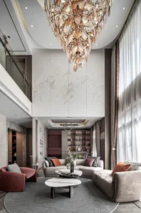 Cozy modern living space with a chandelier, vases, plants, and comfortable furniture