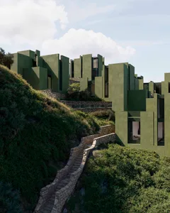 Modern building with a green exterior, surrounded by a lush hillside, featuring large windows for natural light and a serene atmosphere