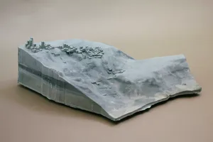 3D model of a modern city with a variety of buildings, including a large central structure and smaller surrounding structures, set against a gray background