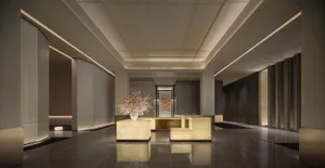 Well-lit modern room with a marble floor, a couch, chair, and dining table, featuring a vase with flowers and clean lines and minimalistic design elements