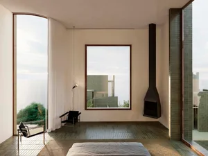 Cozy modern living room with a bed, chair, and couch, decorated with a fireplace, and natural light from windows