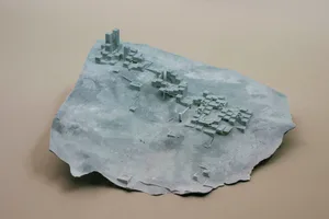 3D model of a city with a gray rock surface, featuring modern concrete buildings and a futuristic urban landscape