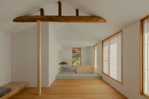 Bathroom with a wooden floor, bathtub, sink, and window, featuring a warm and inviting atmosphere with natural light