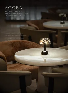 A modern restaurant dining area with a central table surrounded by chairs in various orientations, creating a welcoming atmosphere