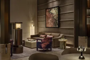 Cozy modern living space with a brown couch, wooden floor, and soft warm lighting
