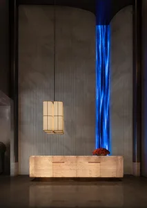 A modern kitchen with a wooden counter and a blue light shining on it, creating a visually striking space