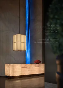 A cozy living space with a wooden desk, a blue light, and a vase of flowers, creating a warm and inviting atmosphere