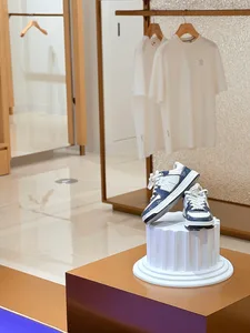 A well-lit shoe store with a display of shoes on a pedestal, arranged in a visually appealing manner