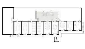 Black and white architectural floor plan of a long narrow restaurant featuring multiple dining rooms, a large outdoor terrace with trees, kitchen, and restrooms.