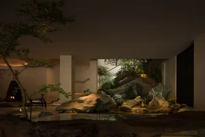 Modern indoor garden featuring large natural rock formations, a koi pond, bonsai trees, a black fireplace, and dramatic uplighting in a contemporary living space.