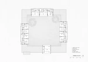 Black and white architectural floor plan of a U-shaped hotel's second floor, showing room layouts, corridors, elevator lobbies, and a large central courtyard with trees.