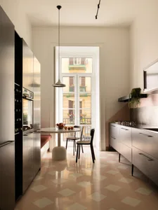 Modern compact kitchen with pink terrazzo tile floor, stainless steel cabinetry, round marble dining table, and large glass doors opening to a balcony.
