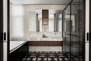 Modern luxury bathroom with white marble walls, dark wood floating vanity with integrated marble countertop and double sinks, black and white geometric patterned floor tiles, freestanding bathtub, and glass-enclosed shower.
