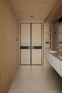 Modern minimalist bathroom with light oak fluted wall panels, double-door oak cabinet with black metal frame, and a white marble floating vanity under a large mirror.