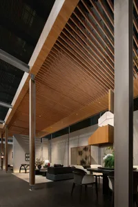 Modern luxury open-plan living and dining area featuring an extensive wood slat ceiling, dark tiled floor, concrete pillars, and contemporary furniture.