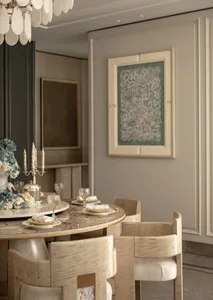 Elegant dining room with round marble dining table, light oak upholstered chairs, shell chandelier, and large floral artwork on a paneled wall.