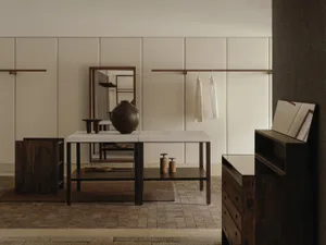 Modern minimalist entryway with dark walnut console table, large ceramic vase, wooden mirror, and hanging white garments against beige paneled walls.