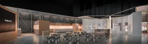Modern industrial-style exhibition hall with a cafe area containing numerous grey concrete stools and tables arranged in an open layout, surrounded by display walls and glass partitions.