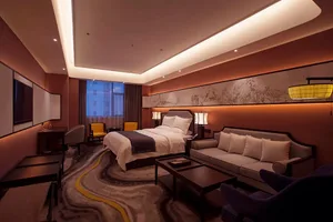 Modern luxury hotel bedroom featuring a large Chinese ink landscape painting, marble-patterned area rug, walnut furniture, and warm ambient lighting.