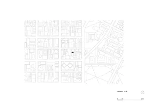 Architectural context plan showing multiple city blocks with floor plans and surrounding streets, with one building marked by a solid black rectangle.