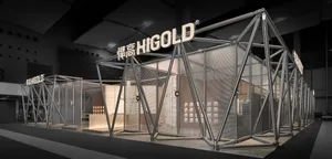 Large-scale geometric exhibition booth constructed from polished stainless steel frames and mesh panels, featuring the Higold brand name in illuminated signage, displayed in a modern exhibition hall.