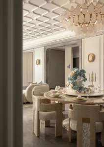 Luxurious dining room with a round mother-of-pearl table, upholstered dining chairs, large floral centerpiece, and dramatic capiz shell chandelier under a coffered ceiling.
