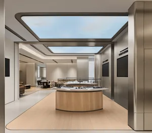 Modern luxury jewelry boutique interior featuring a large curved oak display island, brushed stainless steel walls, light wood flooring, and a large rectangular skylight revealing blue sky.