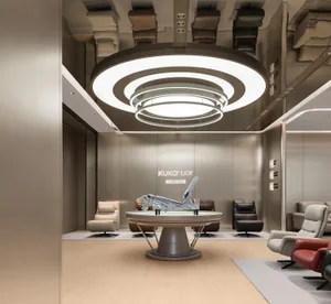 Modern minimalist showroom for KUKA Joy smart recliners with a large circular multi-ring chandelier, neutral leather seating, and light wood flooring.