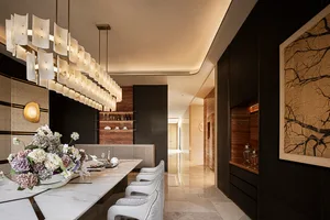 Modern luxury dining room featuring a long white marble dining table, six light grey upholstered dining chairs, a dramatic multi-tiered alabaster chandelier, dark wood paneling, and a large framed ink painting of tree branches.
