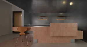 Modern minimalist kitchen featuring a terracotta tiled island counter, raw concrete walls and ceiling, wooden chair, and integrated warm lighting.