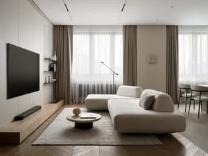 Modern minimalist living room featuring a large L-shaped cream modular sofa, round oak coffee table on a textured rug, wall-mounted TV above a light oak entertainment console, and floor-to-ceiling sheer curtains allowing natural light to flood the space.