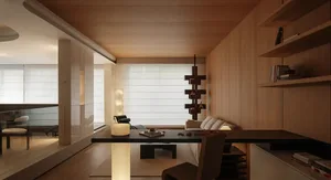 Modern minimalist living room featuring light oak wood paneling, a long floating black desk, sculptural wooden pendant light, and soft ambient lighting from cylindrical floor lamps.